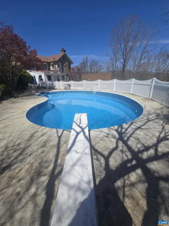 a view of a pool with a yard