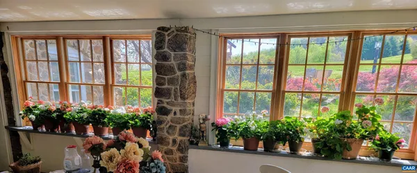 a vase of flowers sitting in front of a window