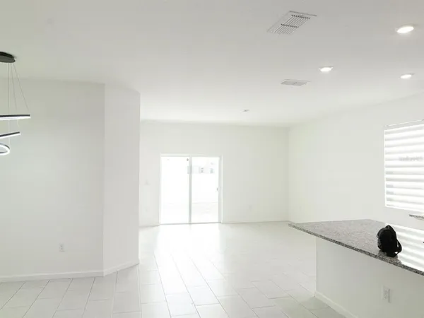 a kitchen with granite countertop a sink a stove a washer and dryer