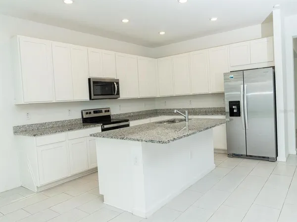 a view of a backyard with plants and lake view