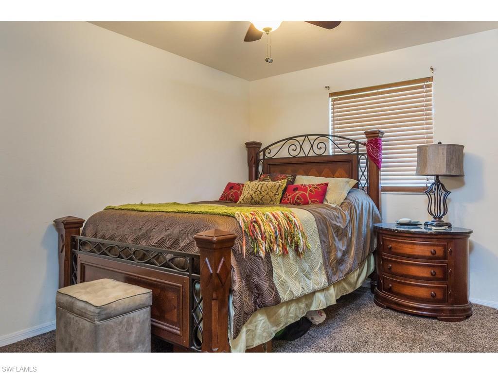 17208 Trellis Road Fort Myers, FL 33967 - Photo 16 of 22 a bedroom with a bed a dresser and a window