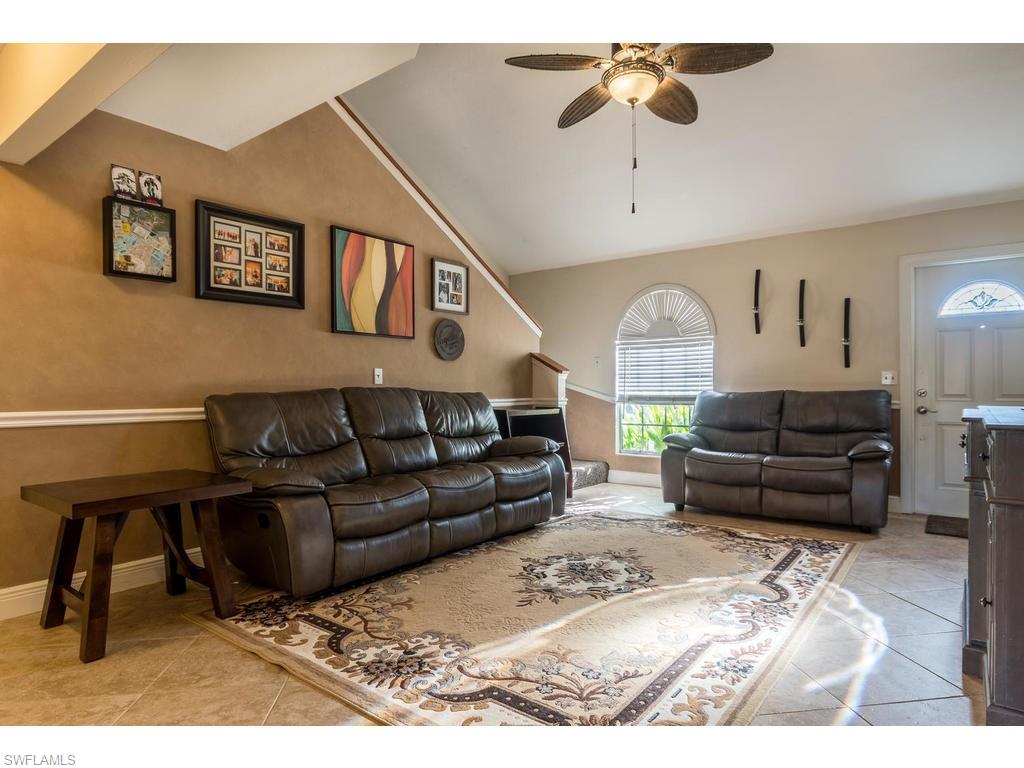 17208 Trellis Road Fort Myers, FL 33967 - Photo 4 of 22 a living room with furniture ceiling fan and a rug