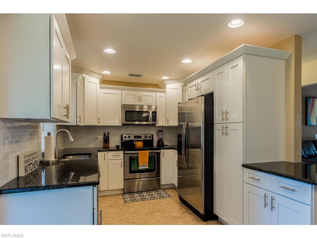 17208 Trellis Road Fort Myers, FL 33967 - Photo 6 of 22 a kitchen with stainless steel appliances granite countertop a refrigerator a sink a stove a microwave and island