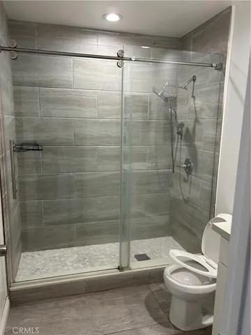 a bathroom with a shower and a toilet