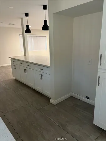 a view of a kitchen with window and cabinet
