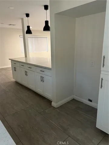 a view of a kitchen with window and cabinet