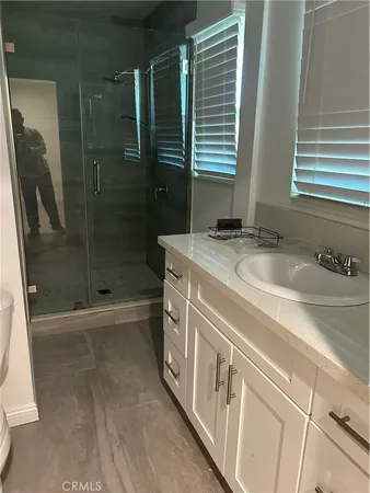 a bathroom with a shower and a sink