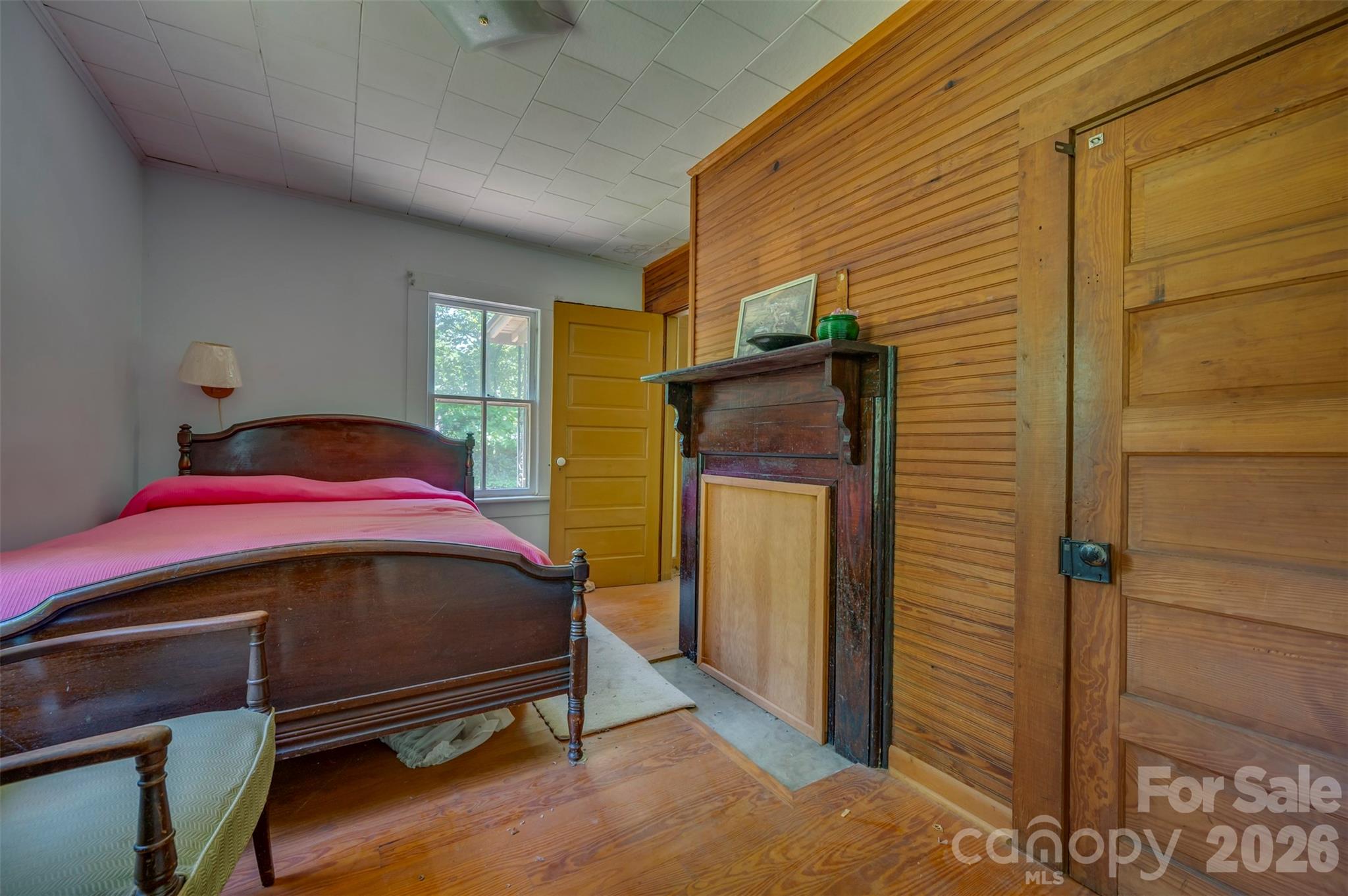 77 1st Street Tryon, NC 28782 - Photo 17 of 20 a bedroom with a bed and a mirror