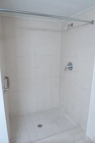 a bathroom with a glass shower door