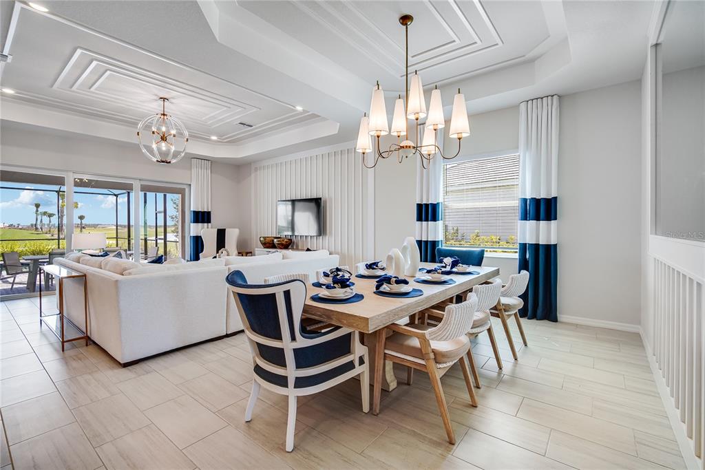 7165 Inlet Isles Lakewood Ranch, FL 34202 - Photo 11 of 26 a view of a dining room with furniture and a chandelier
