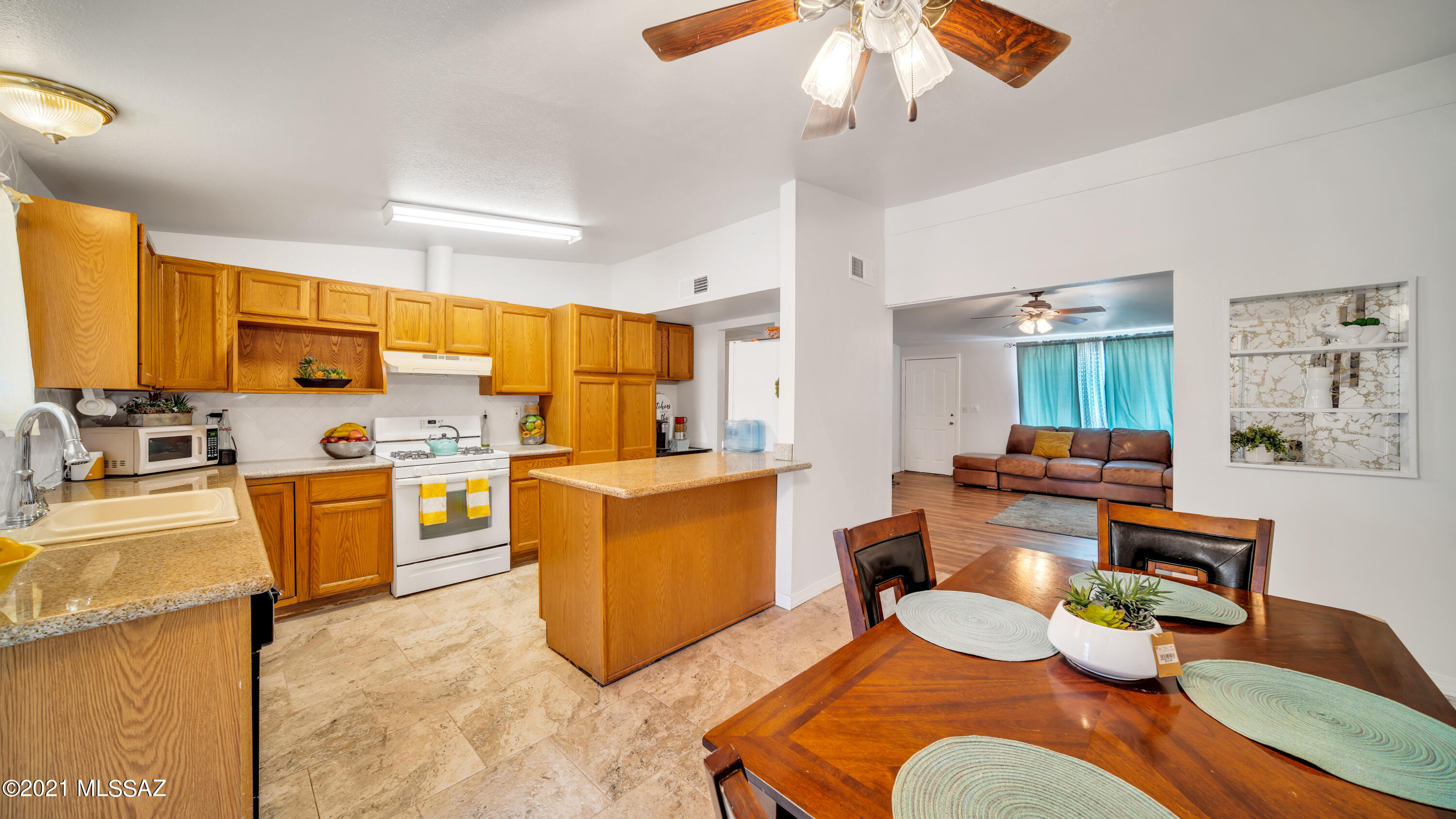 1850 West Saxony Road Tucson, AZ 85713 - Photo 11 of 33 a living room with furniture kitchen view and a refrigerator