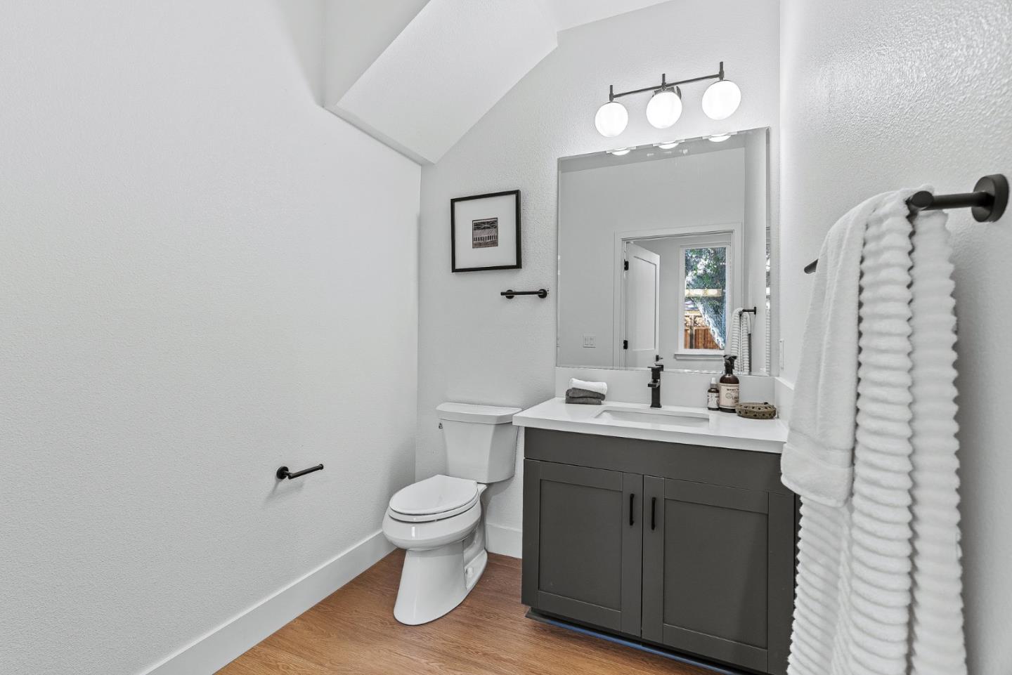 943 Woodside Road Redwood City, CA 94061 - Photo 28 of 30 a bathroom with a toilet a sink and mirror