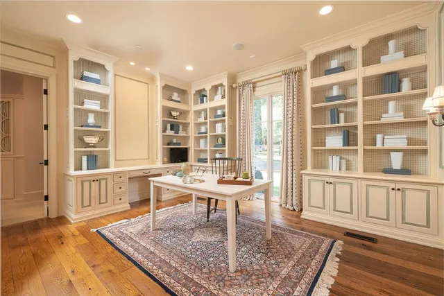 a living room with furniture wooden floor and a rug
