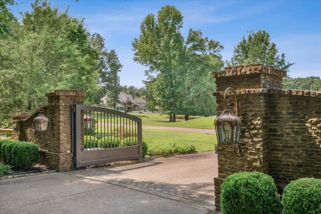 a view of a entrance gate of a house with a garden