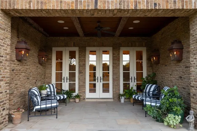 a view of a patio with a table and chairs