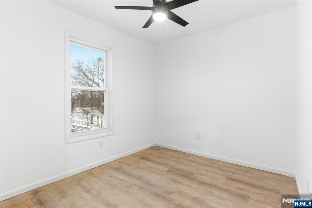 528 South 13th Street, Unit 2 Newark, NJ 07103 - Photo 14 of 21 an empty room with a window and ceiling fan