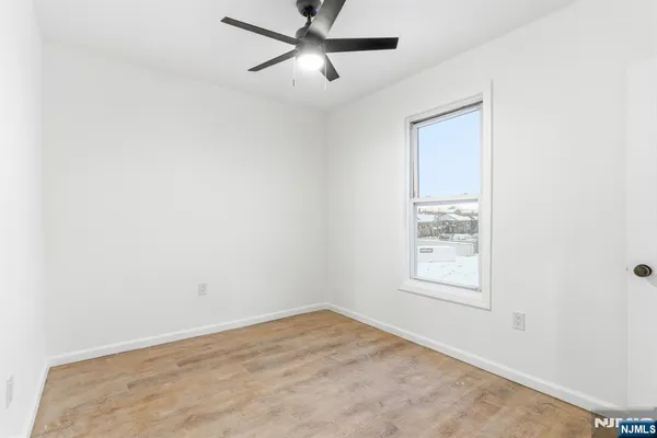 an empty room with windows and closet