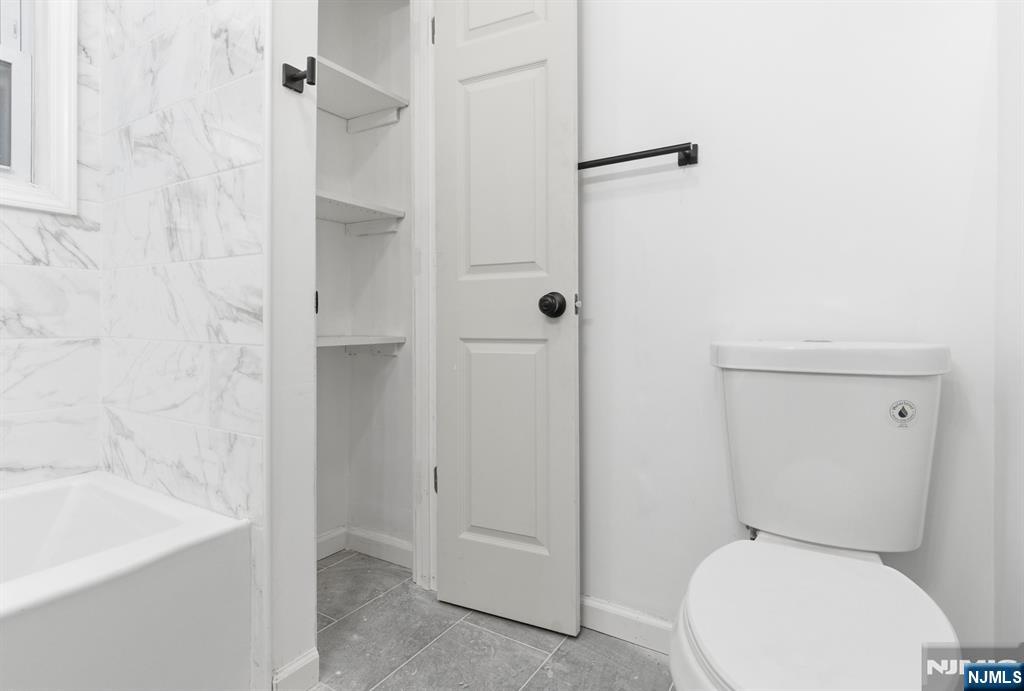 528 South 13th Street, Unit 2 Newark, NJ 07103 - Photo 21 of 21 a white toilet sitting next to a bath tub