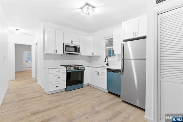 a kitchen with a refrigerator stove and sink