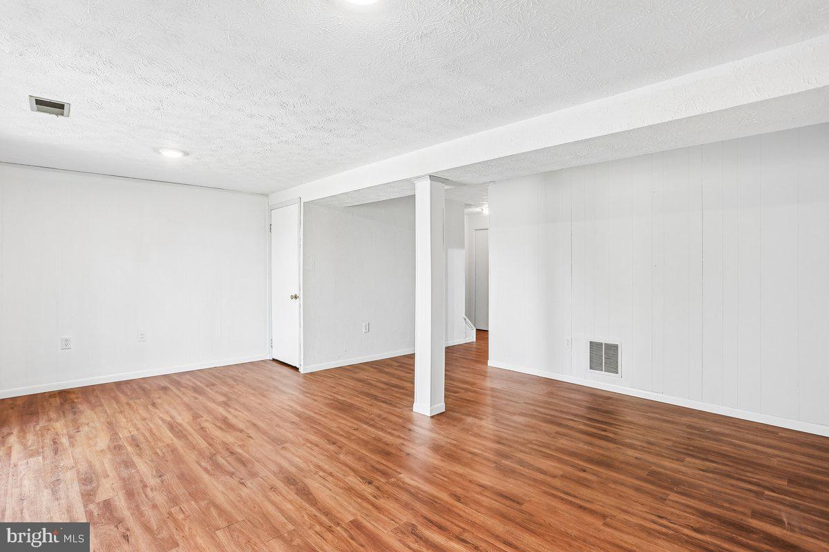 76 Timber Rock Road Gaithersburg, MD 20878 - Photo 38 of 51 a view of an empty room with wooden floor
