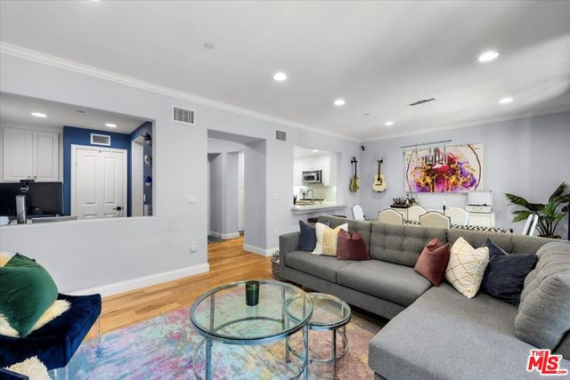 a room with furniture a flat screen tv and a window