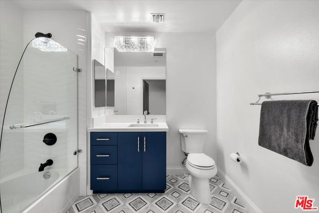 a bedroom with bed and wooden floor