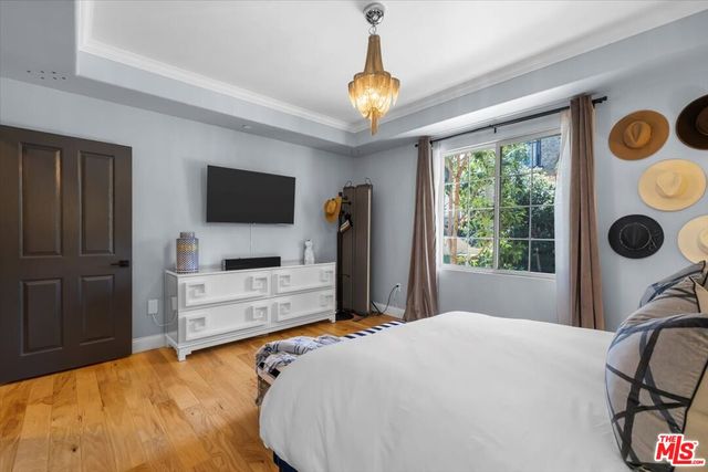 a bedroom with bed and a chandelier