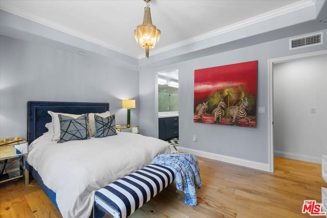 a bedroom with furniture and a flat screen tv