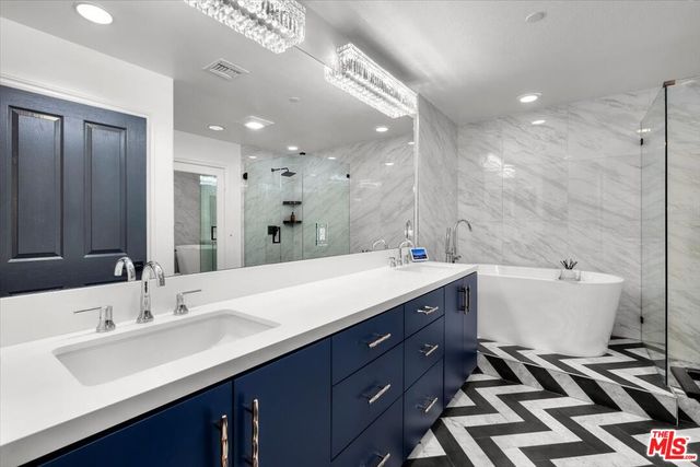 a white bath tub sitting next to a shower