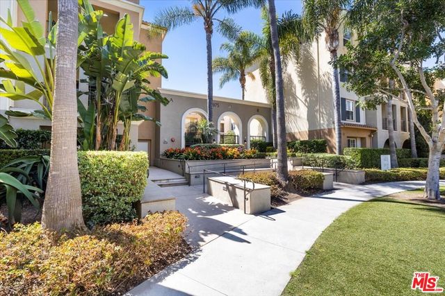 a view of a chairs and table in the balcony