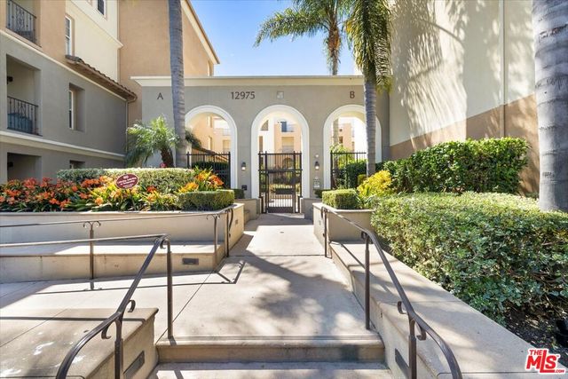 a front view of multiple houses with yard