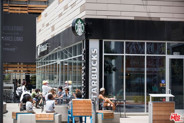 a backyard of a house with a table and chairs