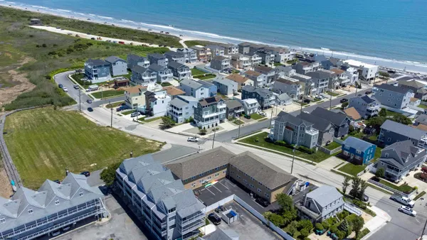 an aerial view of a house with a ocean view