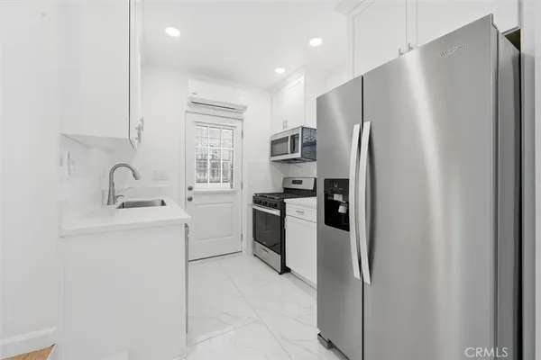 a kitchen with a refrigerator sink and stove