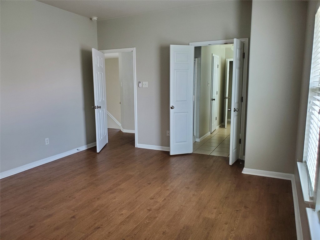 3701 Holden Court Round Rock, TX 78665 - Photo 11 of 21 an empty room with wooden floor and windows