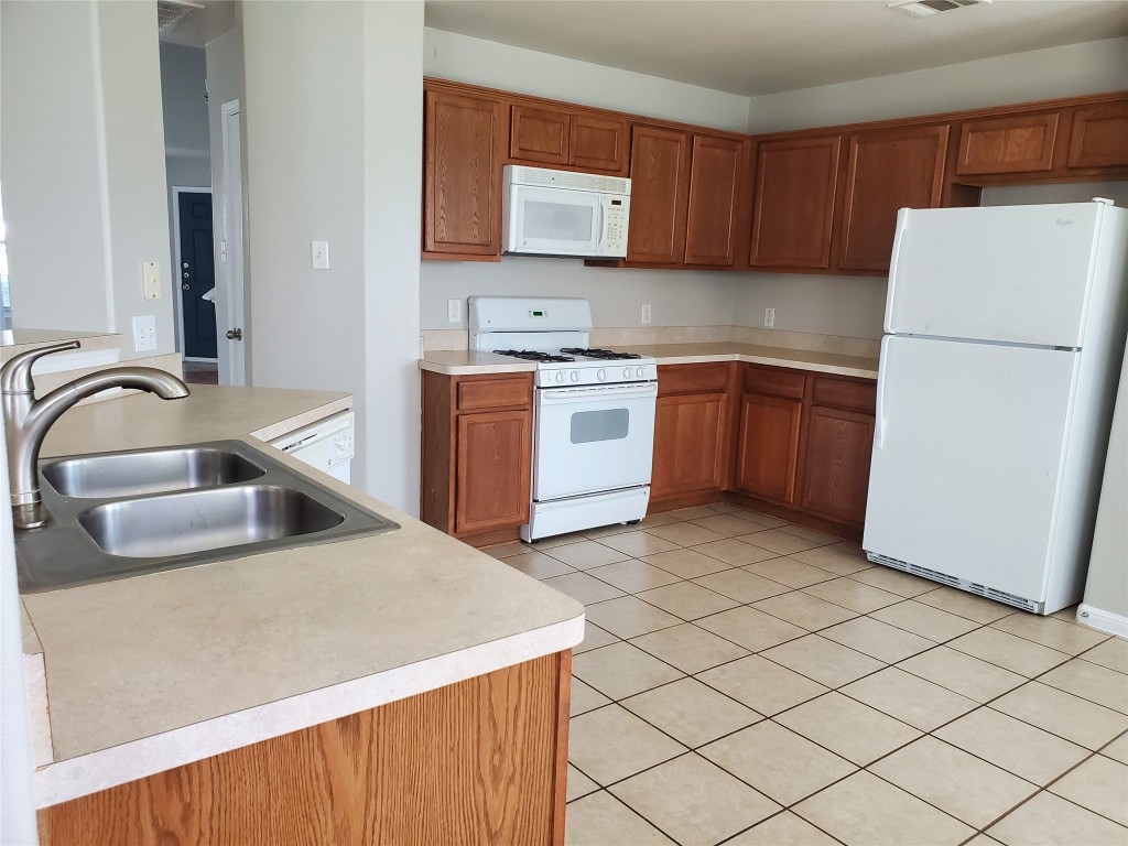3701 Holden Court Round Rock, TX 78665 - Photo 4 of 21 a kitchen with a refrigerator sink and stove
