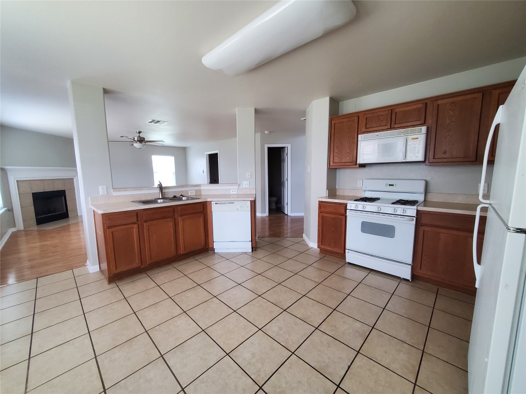 3701 Holden Court Round Rock, TX 78665 - Photo 5 of 21 a kitchen with stainless steel appliances a stove a sink a microwave and a refrigerator