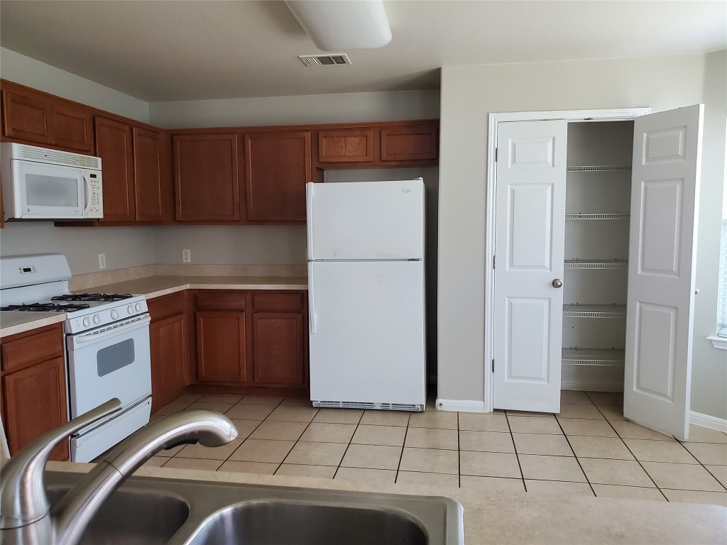 3701 Holden Court Round Rock, TX 78665 - Photo 6 of 21 a kitchen with a refrigerator sink and cabinets