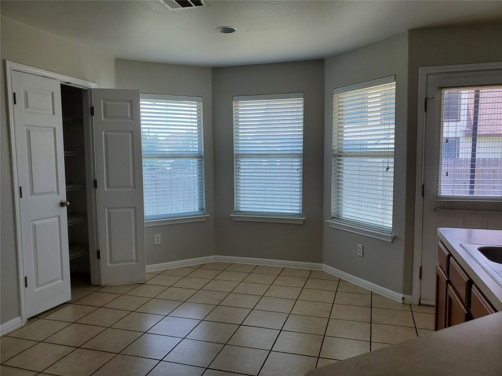 3701 Holden Court Round Rock, TX 78665 - Photo 7 of 21 a view of an empty room with window and cabinet