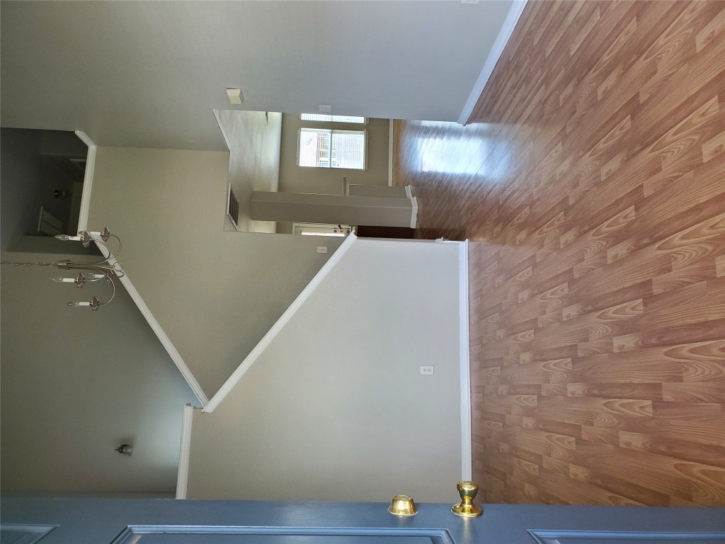 3701 Holden Court Round Rock, TX 78665 - Photo 9 of 21 a view of an empty room with wooden floor and a window