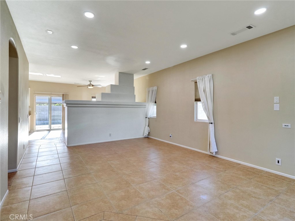 47718 Phoenix Street Indio, CA 92201 - Photo 11 of 54 a view of kitchen and hall with stainless steel appliances granite countertop cabinets