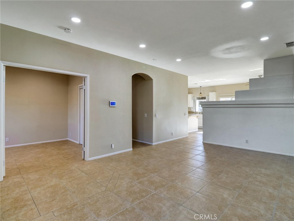 47718 Phoenix Street Indio, CA 92201 - Photo 13 of 54 an empty room with kitchen and entrance