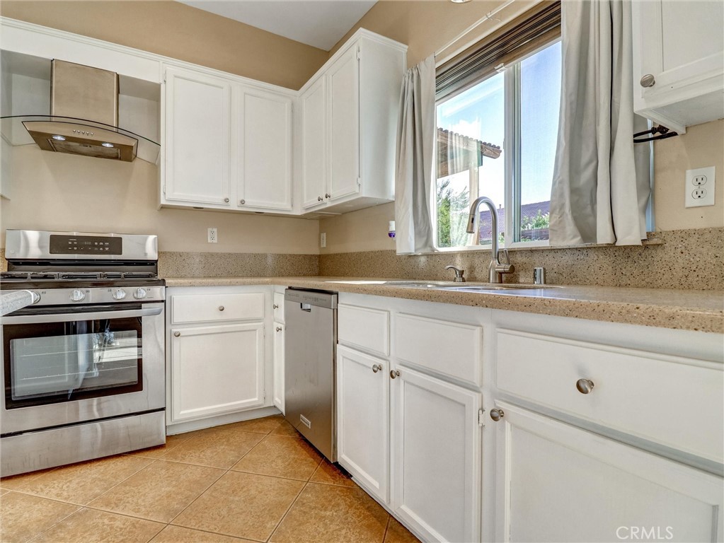 47718 Phoenix Street Indio, CA 92201 - Photo 25 of 54 a kitchen with cabinets appliances and a sink