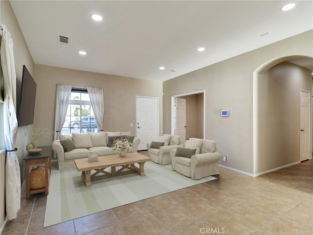 47718 Phoenix Street Indio, CA 92201 - Photo 3 of 54 a living room with furniture and a flat screen tv