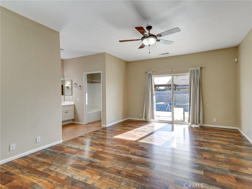 47718 Phoenix Street Indio, CA 92201 - Photo 33 of 54 a view of an empty room with wooden floor and a ceiling fan
