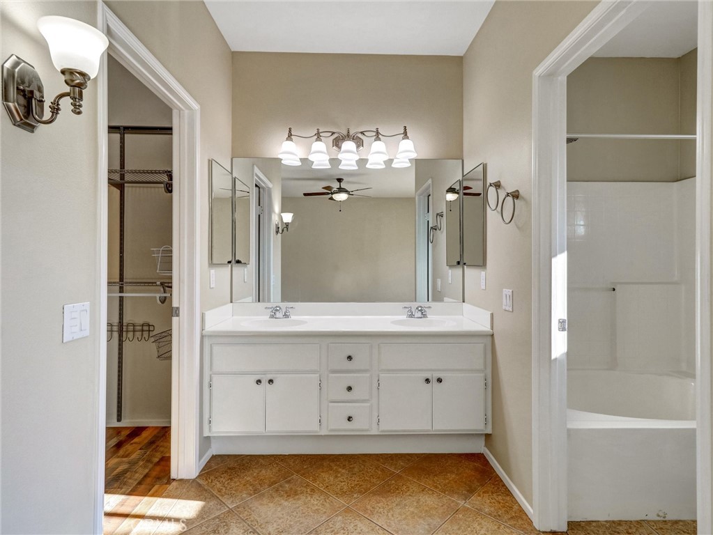 47718 Phoenix Street Indio, CA 92201 - Photo 36 of 54 a bathroom with a tub sink and mirror