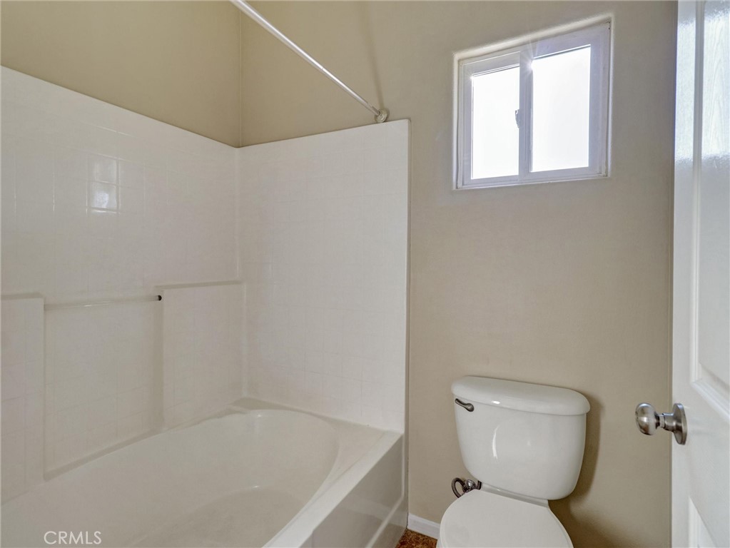 47718 Phoenix Street Indio, CA 92201 - Photo 37 of 54 a white toilet sitting next to a bath tub