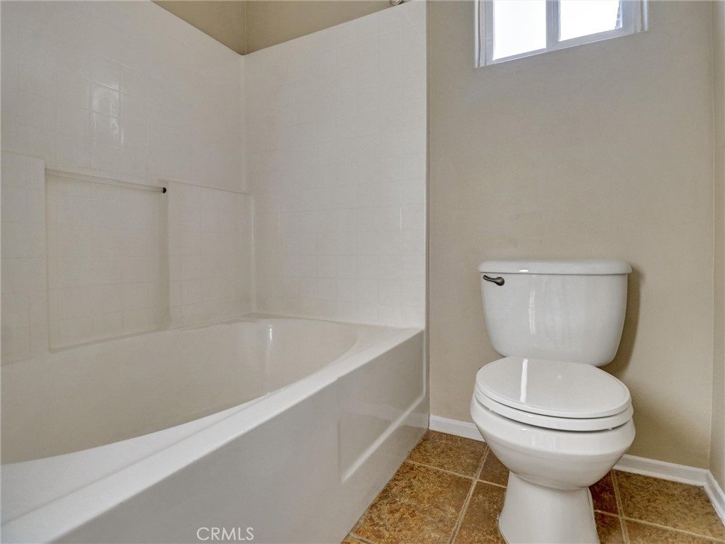 47718 Phoenix Street Indio, CA 92201 - Photo 38 of 54 a bathroom with a toilet a sink and bathtub