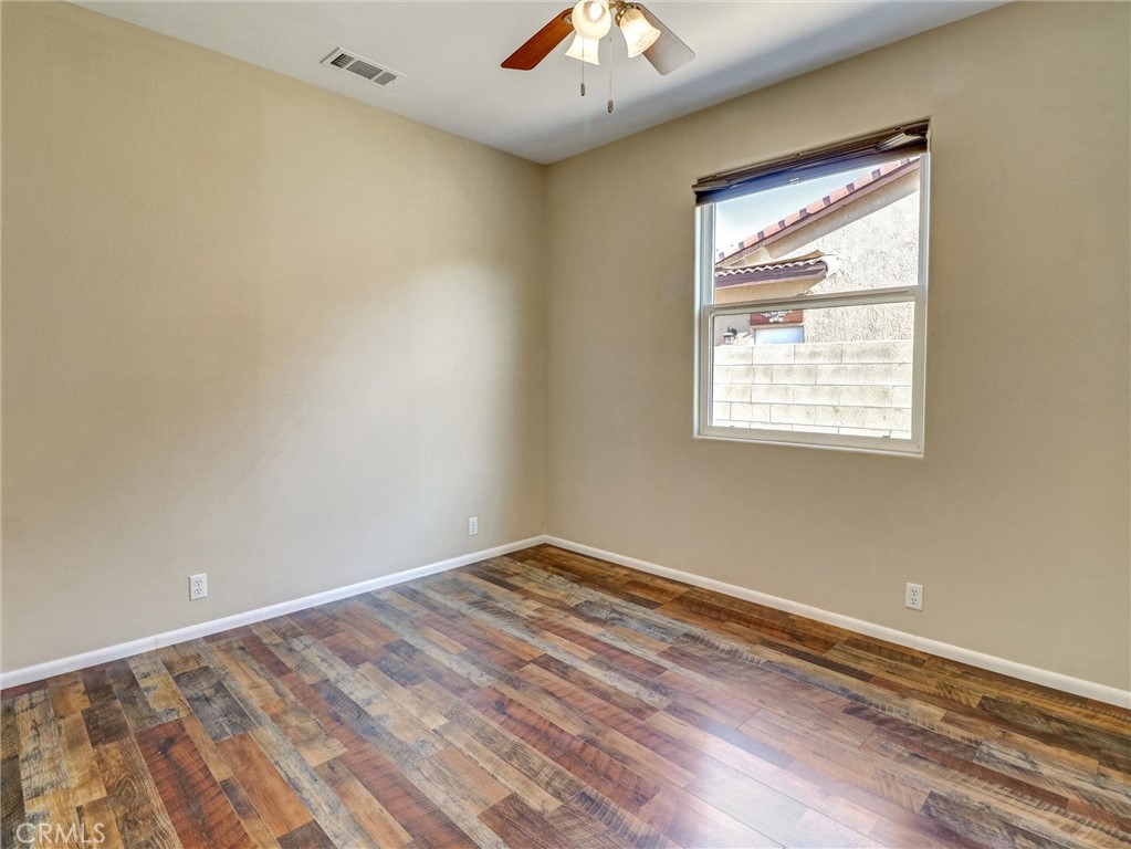 47718 Phoenix Street Indio, CA 92201 - Photo 40 of 54 a view of an empty room with wooden floor and a window