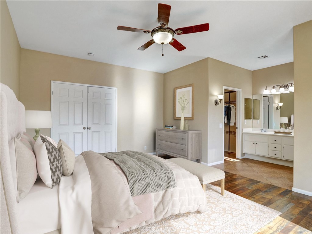 47718 Phoenix Street Indio, CA 92201 - Photo 4 of 54 a bedroom with a bed and a chandelier